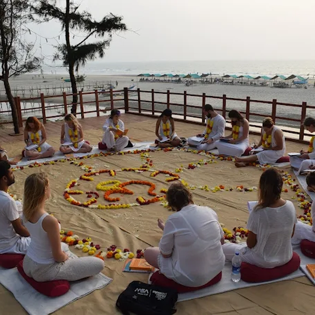 Students in yoga teacher training circle at Oceanic Yoga Morjim Goa during peak season