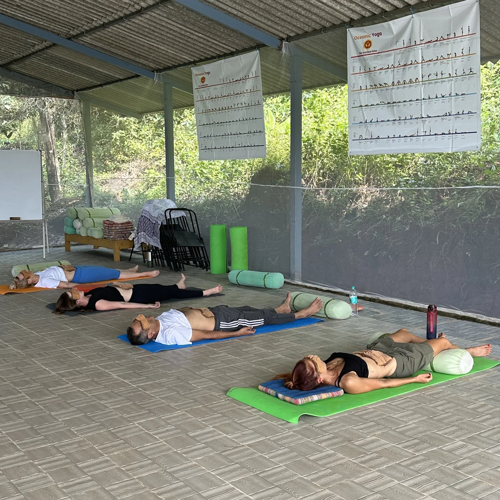 Students in restorative savasana during trauma-informed yoga module at Oceanic Yoga