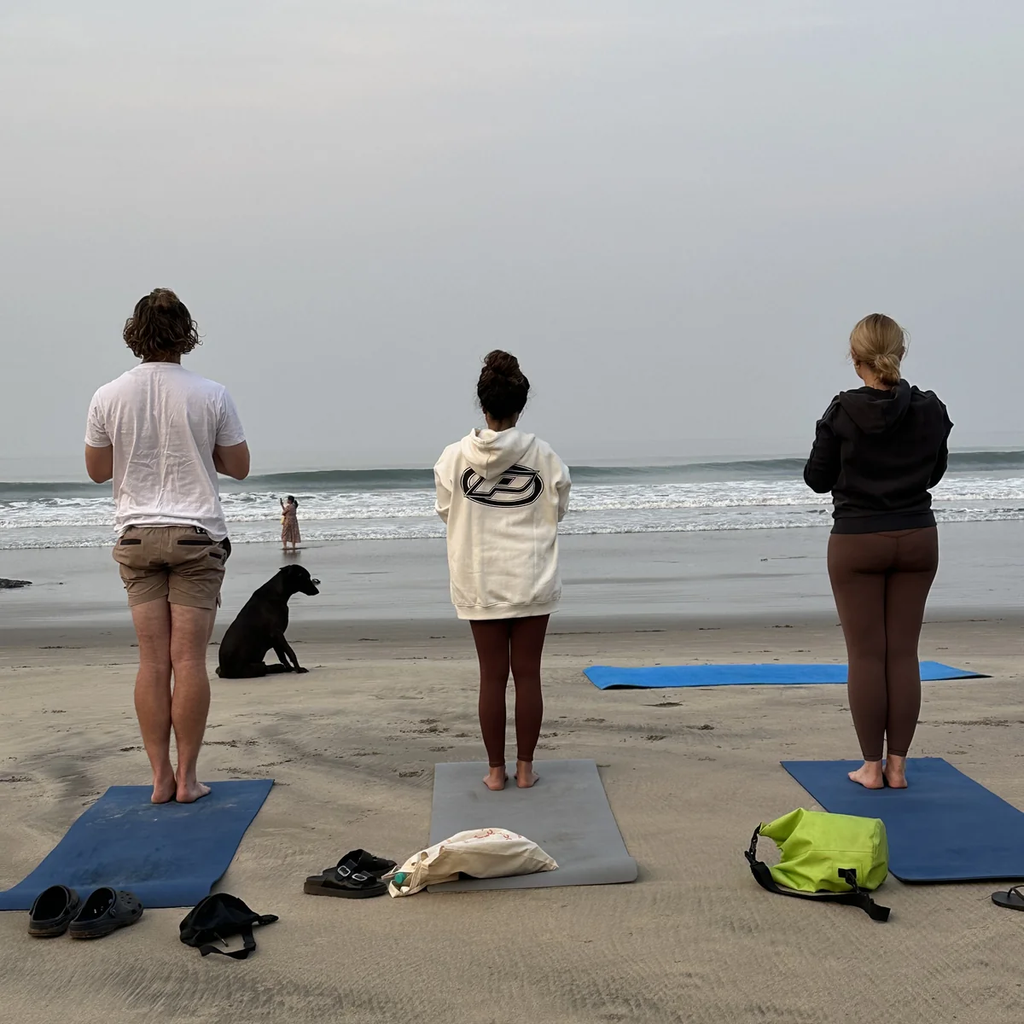 Morning yoga practice on the beach as part of daily YTT schedule in Morjim Goa