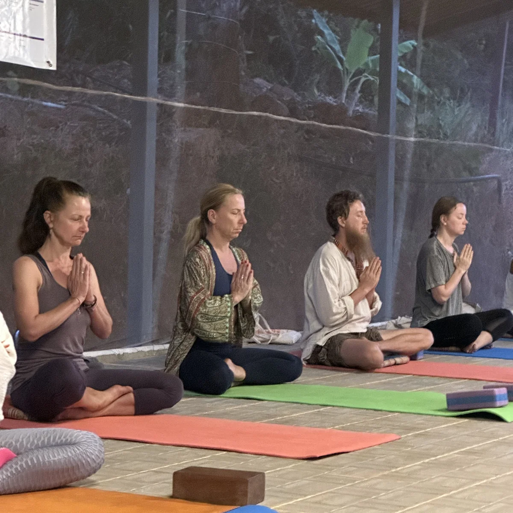 Students in morning meditation and pranayama during yoga teacher training in Goa