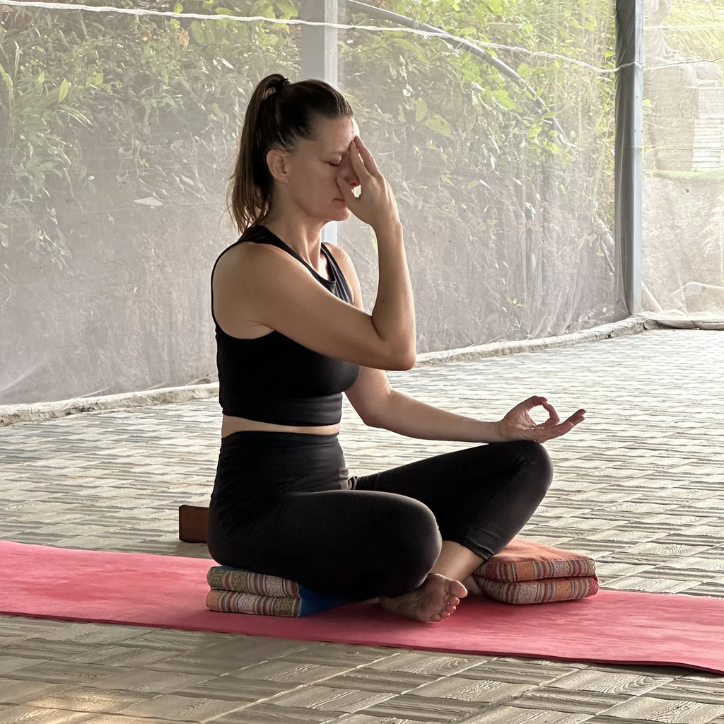Student practicing nadi shodhana pranayama during yoga teacher training in Goa