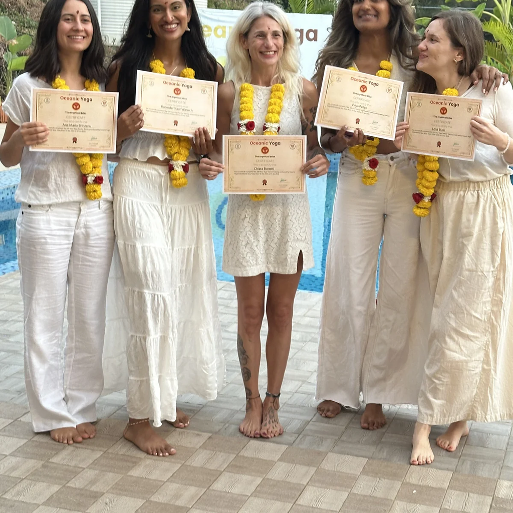 Graduates with Yoga Alliance certificates after completing trauma-informed yoga teacher training in Goa