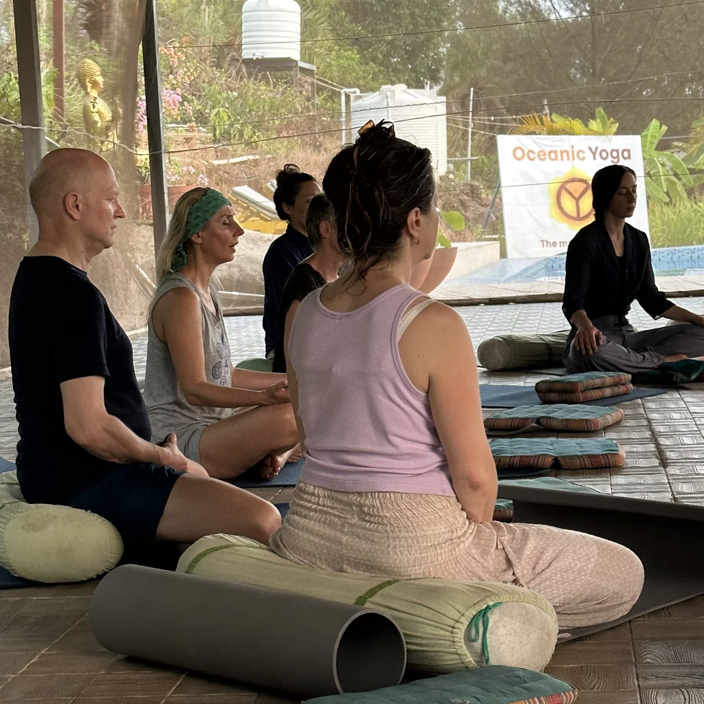 Students in meditation class learning Ayurvedic wellness and yoga philosophy at Oceanic Yoga Goa